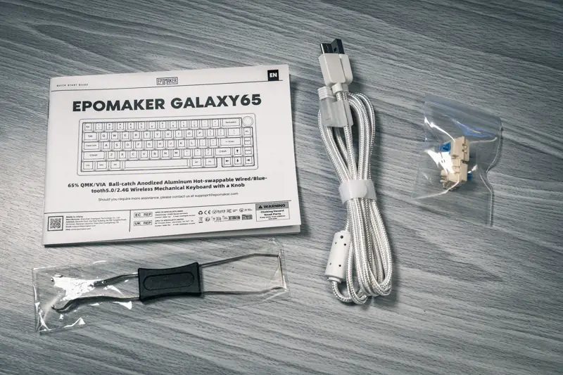 Epomaker Galaxy65付属品の写真 USBケーブル ユーザーマニュアル キーキャップ、キースイッチプラー 替えのキースイッチ(2つ)が写っている